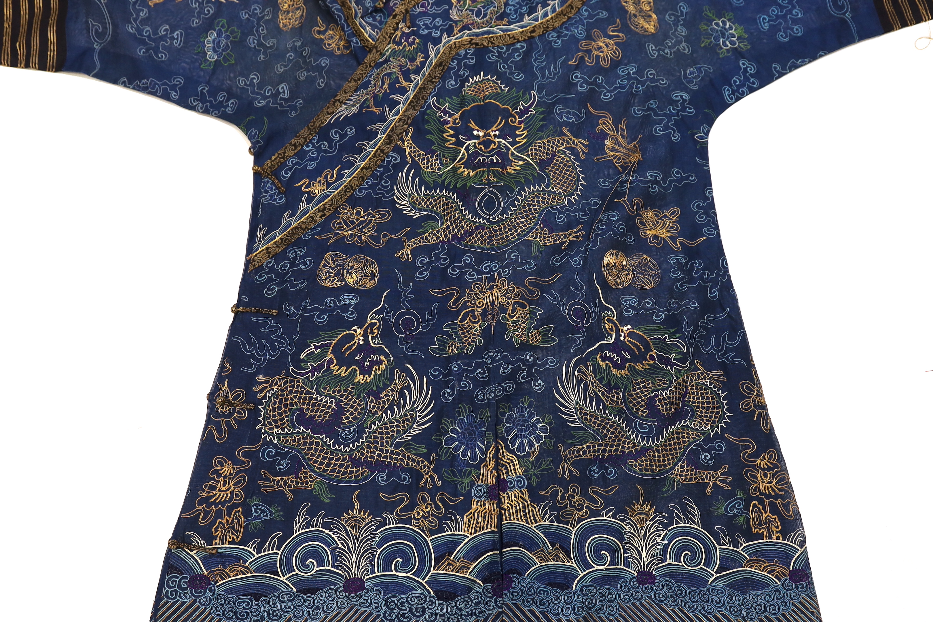 A Chinese fine blue gauze summer robe embroidered with a gold thread dragon highlighted by coloured silk embroidery together with a similar gauze panel embroidered with dragons, 163cm x 75cm